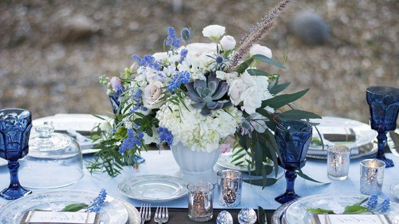 استفاده از اکسسوری های آبی رنک برای تزیین میز مهمانان و جایگاه عروس و داماد برای دکوراسیو آبی تالار عروسی